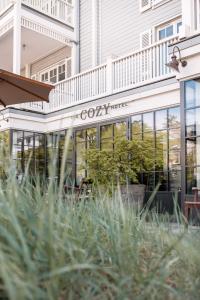 a restaurant with a sign on the side of a building at The Cozy Hotel & Lofts Timmendorfer Strand in Timmendorfer Strand