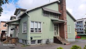 a green house on the side of a building at Oulun Satamahuoneet in Oulu