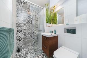 a bathroom with a shower and a sink and a toilet at Close to everywhere, cosy place in Krakow