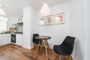 a kitchen with a table and chairs in a room at Close to everywhere, cosy place in Krakow +13 photos