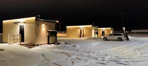 a car parked in a parking lot covered in snow at Hotel OmaBox - Ylivieska - Oma huoneisto saunalla in Ylivieska