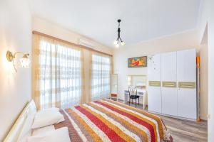 Un dormitorio blanco con una cama y un escritorio. en Apartment #5, en Tiflis