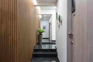 a hallway with a plant in a vase on the floor at Boavista Executive Studios in Porto