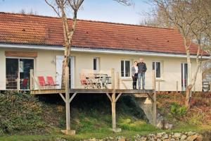 two people standing on a deck of a house at gite au calme au coeur du vignoble Nantais 