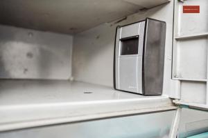 a microwave sitting on a shelf in a room at Apartment in the heart of Oerlikon in Zurich