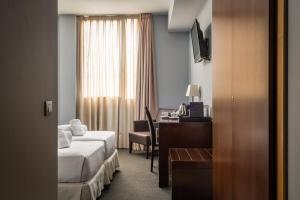 a hotel room with a bed and a desk at Hotel Madanis in Barcelona