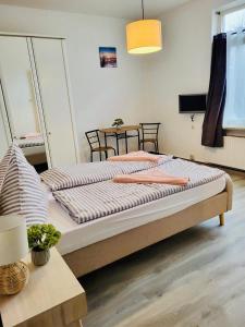 a bedroom with two beds and a table at Haus Deitje in Borkum