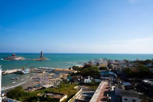 a view of a city with a harbor and the ocean at HOTEL SEBAA PALACE in Kanyakumari