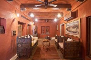 a living room with couches and a ceiling at Kaladwas Lal Haveli - A Heritage Boutique Hotel in Udaipur