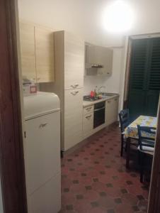 a small kitchen with a refrigerator and a table at Firenze in Bnb in Florence