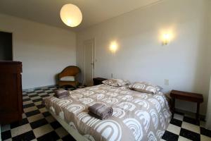 a bedroom with a large bed with a checkered floor at Luberon Large House 4 bedrooms in La Tour-dʼAigues