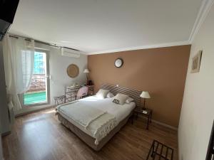 a bedroom with a bed and a large window at Hôtel Ulysse Montpellier Centre in Montpellier