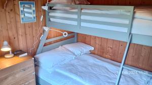 a bedroom with a bunk bed and a desk at Scandinavian Style Lodge in Rock in Wadebridge