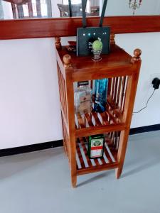 a wooden table with a computer on top of it at Area 51 Apartment in Mirissa