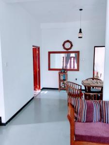 a living room with a couch and a table at Area 51 Apartment in Mirissa