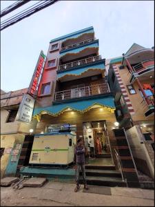 a man standing in front of a building at Hotel JM International (A Unit of Hotel Care Plaza) in Puri