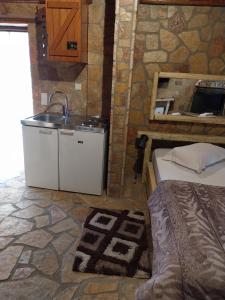 a kitchen with a sink and a bed in a room at Vip Kalavrita in Kalavrita