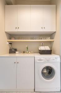 a laundry room with a washer and dryer at Liros House in Nafpaktos