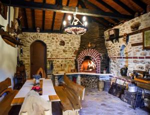 a stone room with a table and a fireplace at Villa Komitata-Pool and Jacuzzi in Balchik