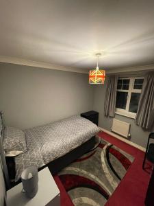 a bedroom with a bed and a table and a lamp at Room 3 - Chassagne Guest House in Church Coppenhall