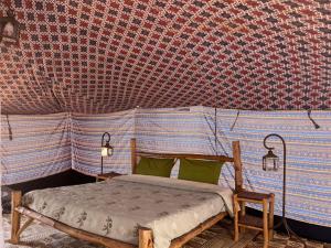 a bedroom with a bed in a tent at Camp Rêve de Nomade in Lompoul