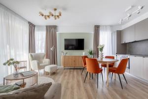 a kitchen and living room with a table and chairs at Dream Garden Apartment - Free Parking - Welness Jacuzzi SPA in Sinaia