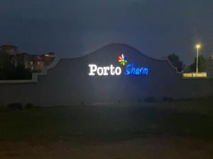 a sign for a porto shanghai at night at Porto Sharm in Sharm El Sheikh