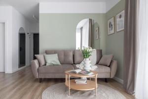 a living room with a couch and a table at Dream Garden Apartment - Free Parking - Welness Jacuzzi SPA in Sinaia