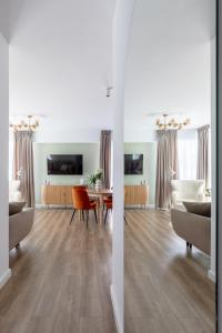 a living room with a table and chairs at Dream Garden Apartment - Free Parking - Welness Jacuzzi SPA in Sinaia +28 photos