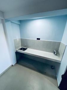 a bathroom with a sink and a blue wall at Micro wood cabana in Nuwara Eliya