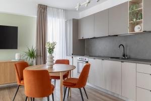 a kitchen and dining room with a table and chairs at Dream Garden Apartment - Free Parking - Welness Jacuzzi SPA in Sinaia