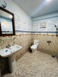 a bathroom with a sink and a toilet at Micro wood cabana in Nuwara Eliya