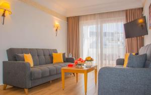 a living room with a couch and a table at Hotel Timoulay and Spa Agadir in Agadir