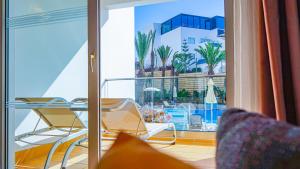 a room with a balcony with a view of a building at Hotel Timoulay and Spa Agadir in Agadir