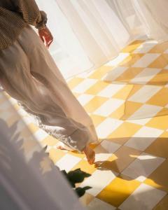a person standing on a yellow and white checkered floor at UNIQUE Villas Lajares - Only Adults in Lajares