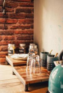 a wooden table with glasses on top of it at 36 Phô Cô Hotel & Suites in Weimar