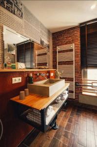 eine Küche mit Spüle und Ziegelwand in der Unterkunft 36 Phô Cô Hotel & Suites in Weimar