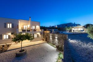 a house with a tree in front of it at night at Princess Sofia Luxury Villa (with private pool) in Kampos Paros