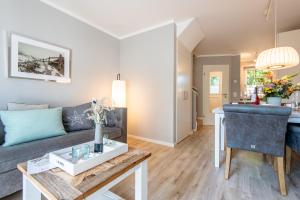 a living room with a couch and a table at Beach House one in Westerland (Sylt)