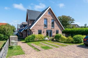 a brick house with a gambrel roof at Beach House one in Westerland (Sylt)