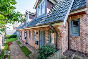 a brick house with a slate roof at Beach House one in Westerland