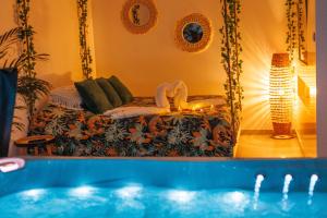 a living room with a bed and a swimming pool at Gîte-Spa Nature in Urschenheim