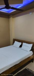 a bedroom with a bed with a blue ceiling at Hotel JM International (A Unit of Hotel Care Plaza) in Puri