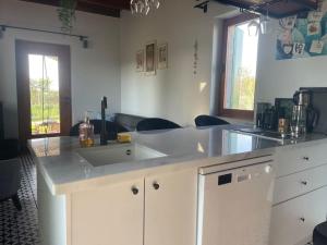 a kitchen with a white counter and a sink at Doğa da bir ev… in Ürgüp