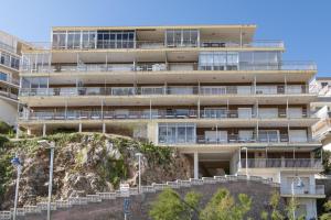 an apartment building on a hill with stairs in front at Hawai Bajo in Faro de Cullera