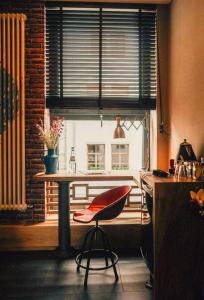a kitchen with a table and a chair in front of a window at 36 Phô Cô Hotel & Suites in Weimar