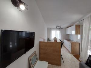 a living room with a large flat screen tv on a wall at Apartments Timee first row to beach in Stanići