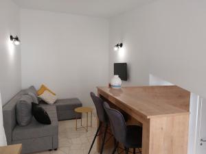 a living room with a couch and a wooden table at Apartments Timee first row to beach in Stanići