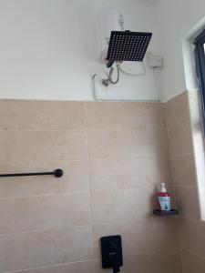 a bathroom with a shower with a fan and a shower at Candy Nyali Sea View Hidden Gem in Mombasa