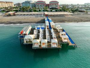 an aerial view of a dock with boats in the water at Orange County Belek in Belek